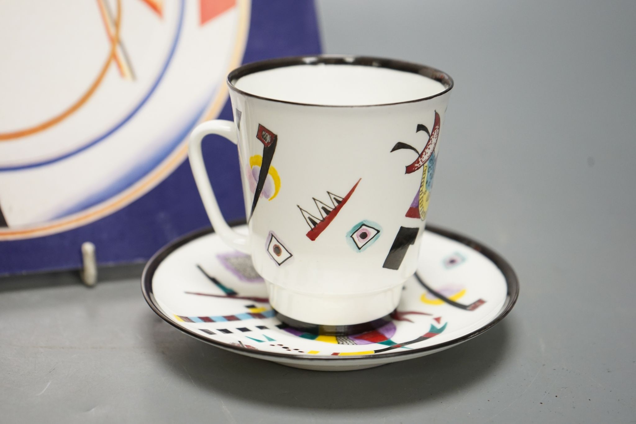 Russian Suprematist-style coffee cup and saucer, 20th century, together with a volume of Revolutionary Ceramics by Nina Lobanov-Rostovsky